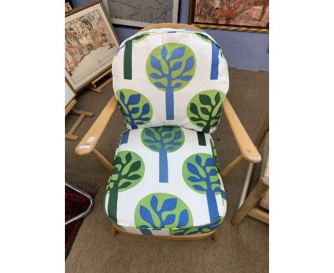 A vintage Ercol lightwood armchair with later upholstery
