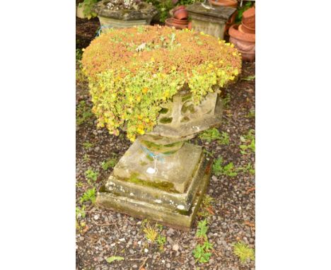 AN OCTAGONAL ECCLESIASTICAL STONE PLANTER with quatrefoil design to perimeter on a seperate base, diameter 68cm x height 88cm