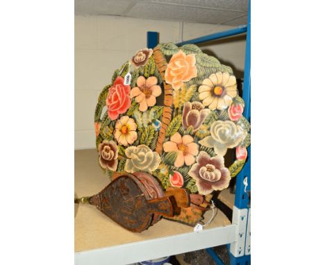 A NOVELTY FIREGUARD, shaped as a basket of flowers, height 47cm, together with a pair of bellows (2)