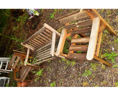 A TEAK SLATTED BENCH, together with a pair of similar armchairs (3)