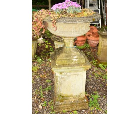 A LARGE CIRCULAR STONE PLANTER, lattice perimeter on a seperate base supported on a square composite column, diameter 80cm x 