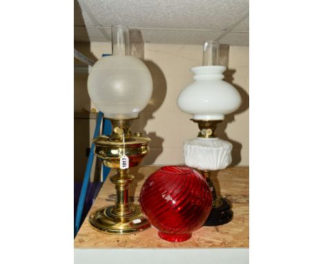 A BRASS OIL LAMP, with glass shade, approximate overall height 58cm, together with another oil lamp, glass shade, approximate