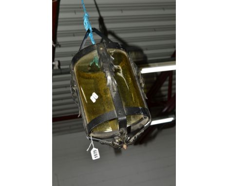 A WROUGHT IRON AND SMOKED YELLOW GLASS CYLINDRICAL HANGING LANTERN