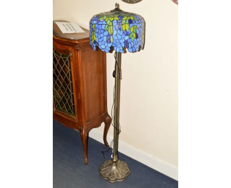 A TIFFANY STYLE STANDARD LAMP with a blue and green ground, shade on column upright and shaped base, height 150cm