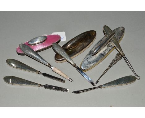 A BAG OF SILVER MOUNTED AND HANDLED MANICURE ITEMS, including a nail buffer with pink enamel decoration (parcel)