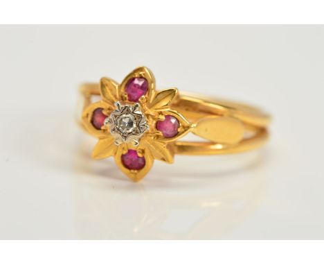 A DIAMOND AND RUBY CLUSTER RING, designed as a central single cut diamond within a star setting above a flower shape surround