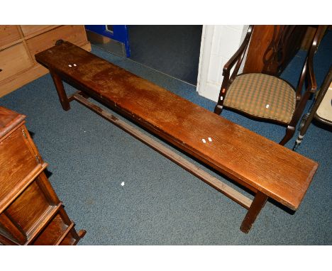 AN EARLY 20TH CENTURY OAK BENCH on a stretchered base, width 185.5cm