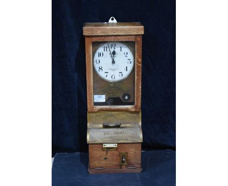 A National Electric Time Recorder (Leeds) Ltd Clocking In Machine, with glazed panel to the front, with gilt writing 'Nationa
