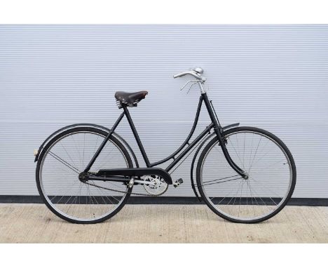 A vintage Upright Bicycle, with 56cm/22'' frame, painted black, with brown Brooks size S saddle, rear reflector, re-painted h