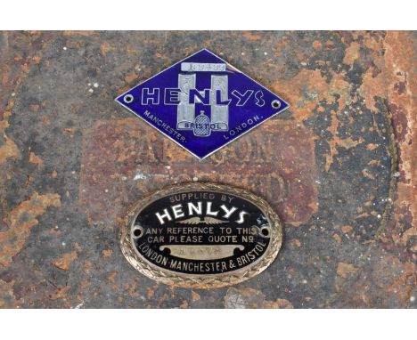 Henlys, two vintage enamelled car dash badges, one in the form of a diamond, serial B9499, the other oval with wreath surroun