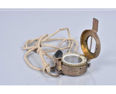 A WWII T.G.Co.Ltd MkIII pocket compass, dated 1940, stamped with a broad arrow, also faintly stamped 'MILS MK.I'