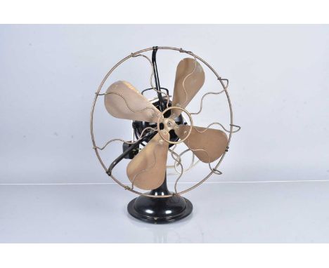 A vintage table top/desk fan, with wire frame, heavy, untestedsold as seen, untested, ome white paint flecks to the blades, o