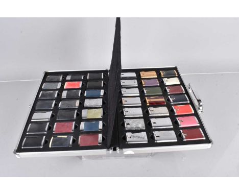 An assortment of Ronson Varaflame Comet pocket lighters, the collection consisting of 42 variously decorated lighters, includ