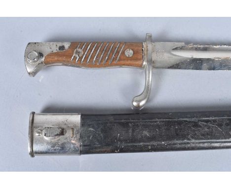 A scarce German 98/05 Parade Sawback bayonet, by WKC, 37.5cm long blade, with plated pommel and cross guard, complete with sc