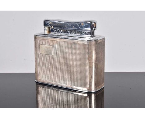 A Colibri Monopol silver table lighter, by C.L.Ld, with four engine turned panel design, with plain cartouche to the front, u