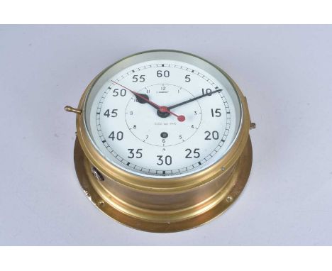 A WWII Period Naval brass bulkhead clock, marked with a broad arrow, with serial 0552/461-9412, the glass is approx. 20cm in 