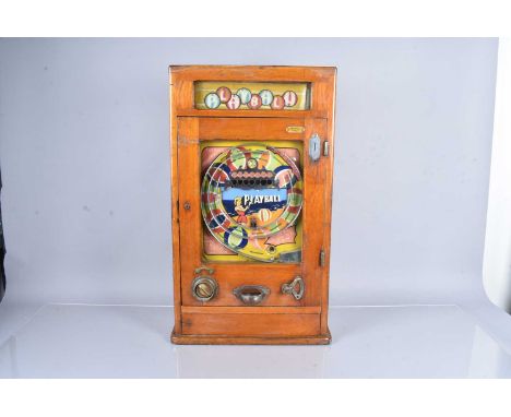 A vintage 'Playball' Penny Arcade machine, with decorative beach design to the front, 8/1cm H, untestedThis item is sold as s