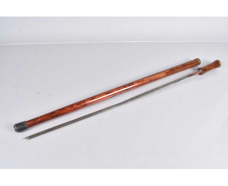 An early 20th Century sword stick, with 71cm long blade, with etched floral design, in wooden shaft, with brass collar and te