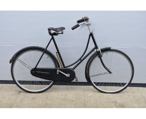A vintage Upright Bicycle, with 63cm/24'' frame, painted black, with Hercules saddle, single speed, black hand grips, front a