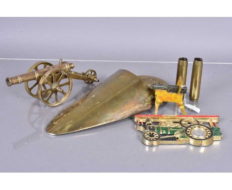 An assortment of trench art and brass items, to include a small cannon, two small shells dated 1944, a brass wall sconce and 