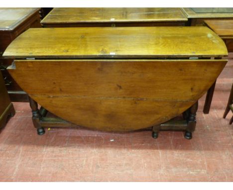 A LARGE ANTIQUE OAK GATE LEG DINING TABLE, oval topped with single end drawer on turned and block supports with substantial s