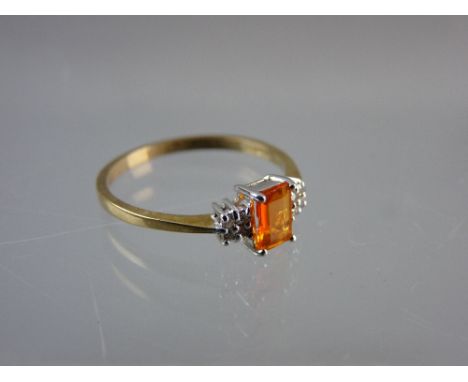 A NINE CARAT GOLD DRESS RING having a centre oblong cut 'fire opal' with flanking diamonds, 1.5 grms