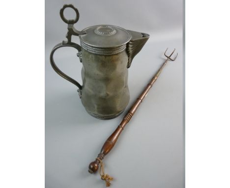 A LIDDED PEWTER FLAGON with hammered facet body and ring thumb piece, angel marked to the base, possibly European 19th Centur