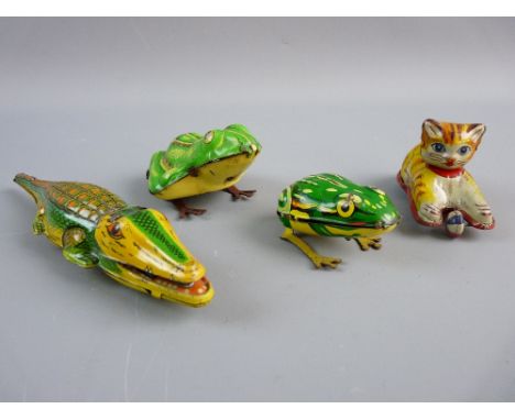 FOUR VINTAGE TINPLATE ANIMALS to include a friction drive kitten with ball, a Gama US Zone, Germany clockwork crocodile and t