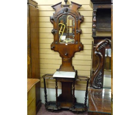 A VICTORIAN MAHOGANY MIRROR BACKED HALLSTAND with white marble centre shelf and cast iron trays (damage to marble)