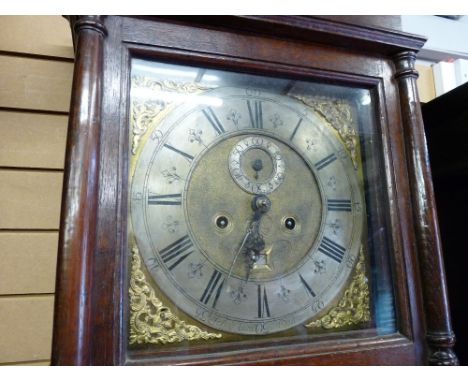 AN 18th CENTURY OAK LONGCASE CLOCK having a wide stepped cornice over a square hood with turned pillars and having a long fie