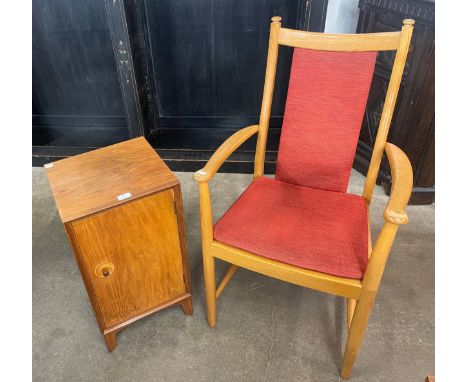 A teak bedside cupboard and an Ercol elbow chair 