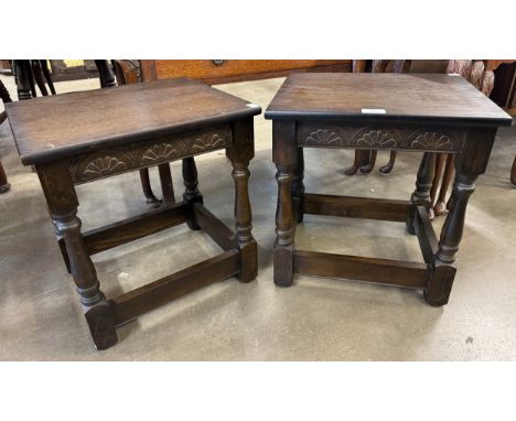 A pair of carved oak lamp tables 