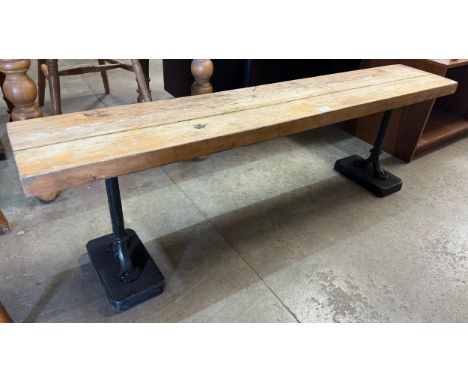 A pine and wrought iron bench 