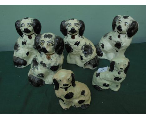 Pair of male and female black and white miniature Staffordshire mantelpiece Spaniel ornaments and 2 other larger pairs in sim