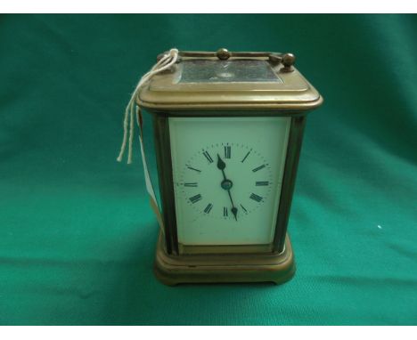 Brass carriage clock with enamel dial painted roman numerals 