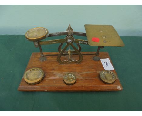 Set of brass letter scales with three brass weights on rectangular oak stand