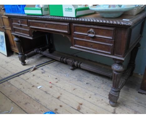 Oak kneehole rectangular topped writing table inset light brown rexine, fitted central and 2 wing double dummy drawers, ornat