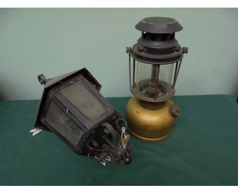 Metal cased, six glazed panel converted light fitting with wall bracket, together with a brass paraffin lamp