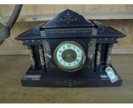 Ornate late Victorian mantel clock in ornate black slated case, circular enamel and brass dial, inset decorative mottled doub