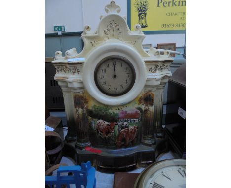 Ornate mantel clock the circular dial within cream and gilt painted case with transfer of cattle below