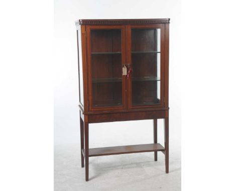 An Edwardian inlaid mahogany display cabinet
Having two glazed doors flanked by glazed side panels enclosing two glass shelve