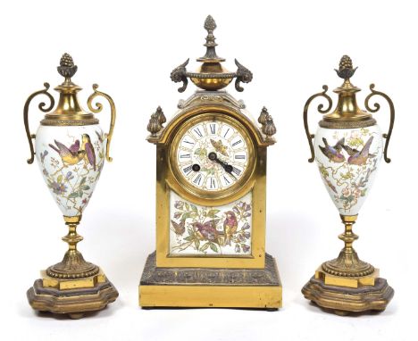 A French late 19th Century gilt metal and enamel eight-day clock garniture 
The central clock with architectural gilt metal c