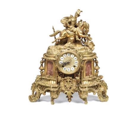An early 20th Century gilt metal French mantle clock
The clock with a cast horse and rider figure above a 9cm dial, flanked b