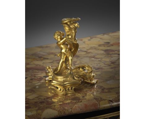 A LOUIS XV ORMOLU ROCOCO CANDLESTICK AFTER A DESIGN BY JUSTE-AURELE MEISSONIER, C.1745 modelled  with a cherub supporting a r