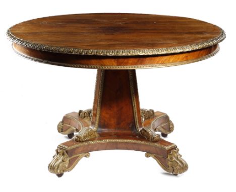 λ A ROSEWOOD AND GILT COMPOSITION CENTRE TABLE 19TH CENTURY the circular fixed top with an egg and dart moulded edge, the fri