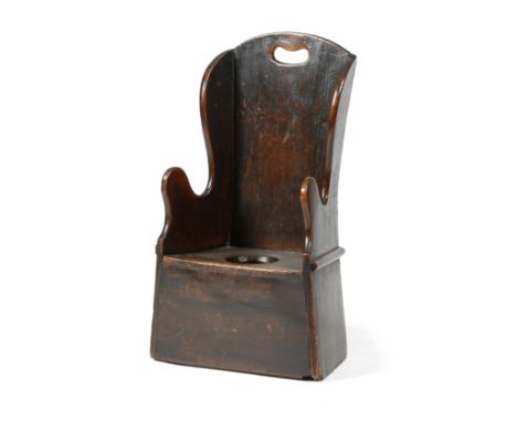 A GEORGE III ELM CHILD'S COMMODE CHAIR LATE 18TH CENTURY pierced with a handgrip, together with a blue and white pearlware po