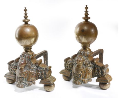 A PAIR OF DUTCH BRASS ANDIRONS 18TH CENTURY each with a turned ball finial, above a shaped base repousse decorated with a por