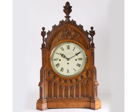 A 19th century oak cased Gothic bracket/table clock by A. Taffinder of Rotherham, having carved floral finials above arched p