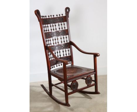 A late 19th century rocking chair in the Moorish style with a pair medallion heads to front rail, possibly by Carlo Bugatti, 