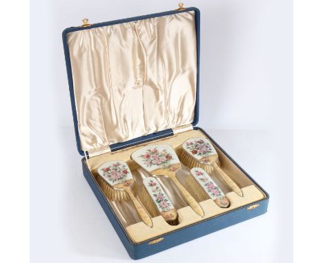 A cased silver and enamel dressing set comprising four clothes brushes and hand mirror, Birmingham 1938, Henry Clifford Davis